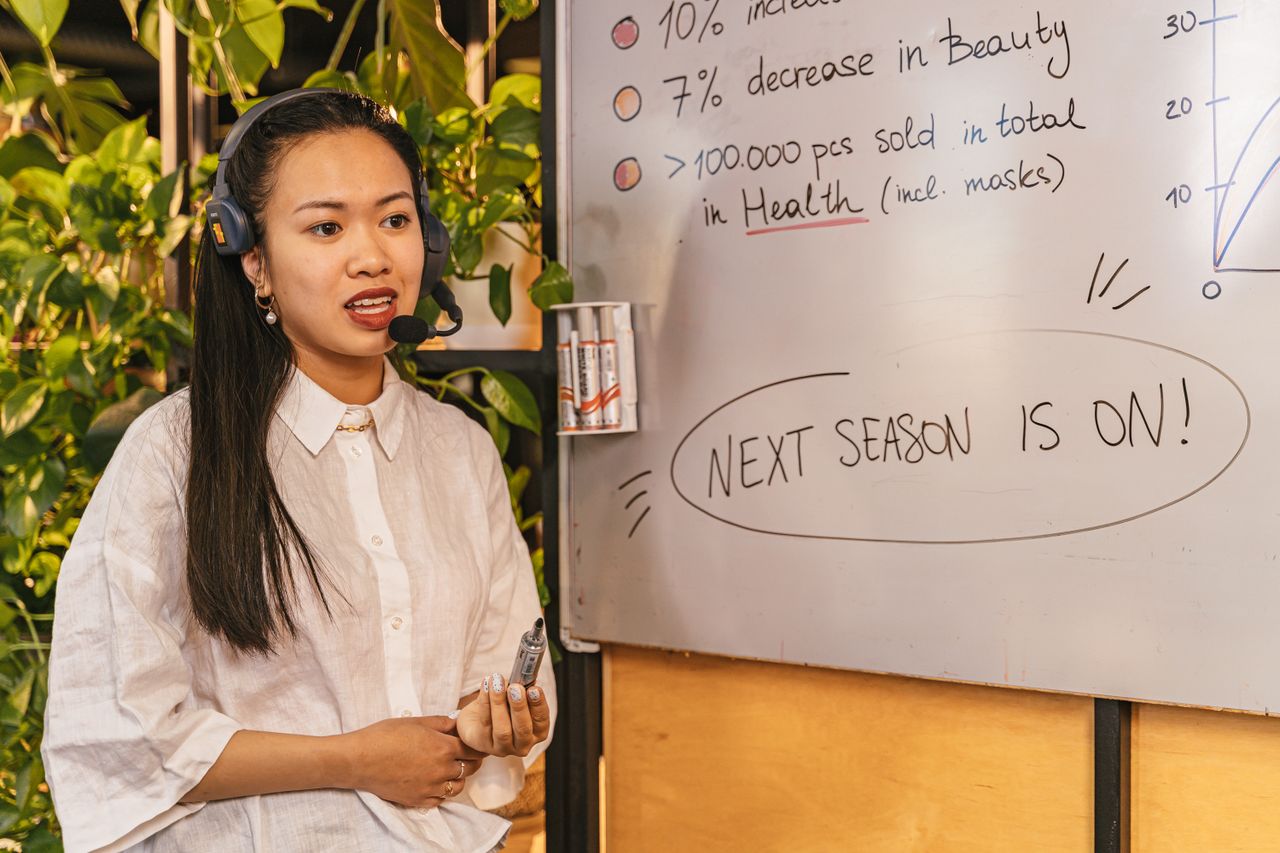 A sales manager planning a pipeline on a whiteboard