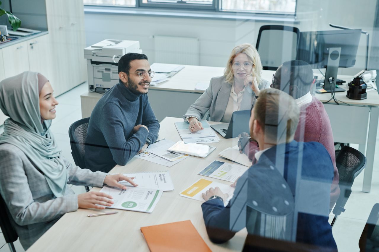 A sales team meeting around an office table